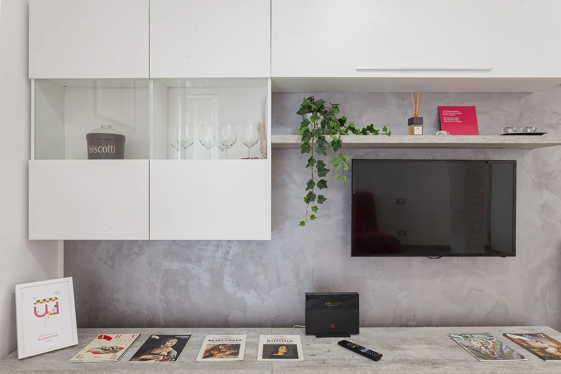 A living room media wall features a television above a low console.