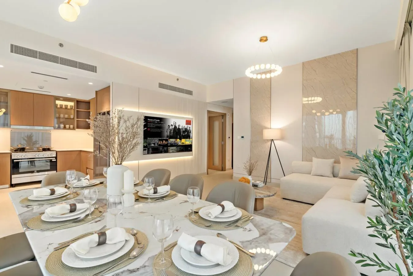 A modern open-plan living and dining area with a set dining table and seating.