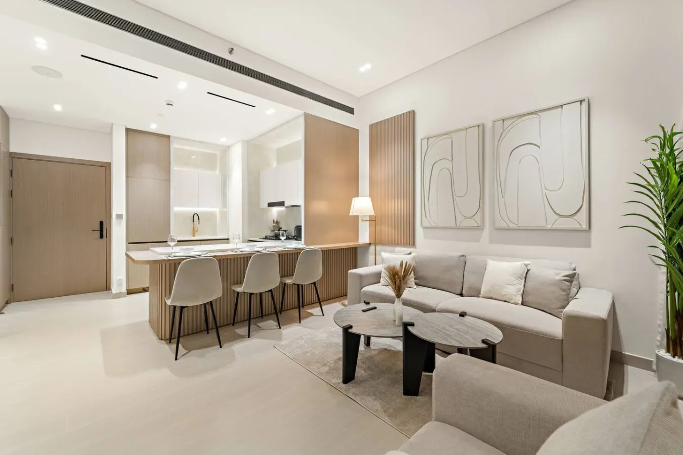 A bright living area with a sofa, coffee table, and kitchen island.