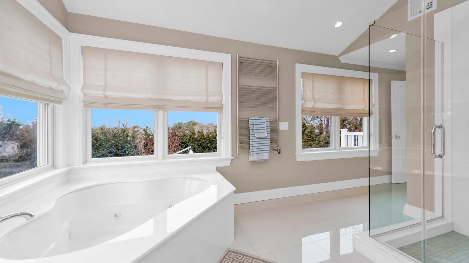 A bright bathroom features a built-in bathtub beside a glass shower.