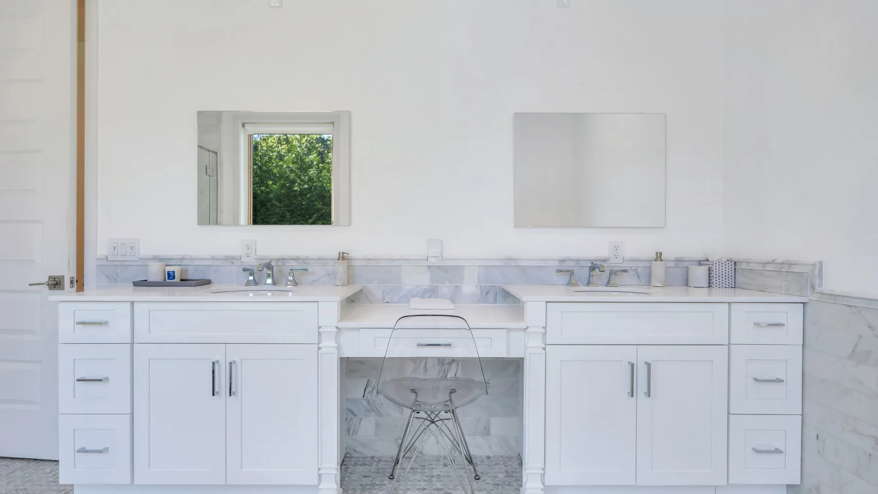 A bright bathroom vanity with a sink, mirror, and small window.