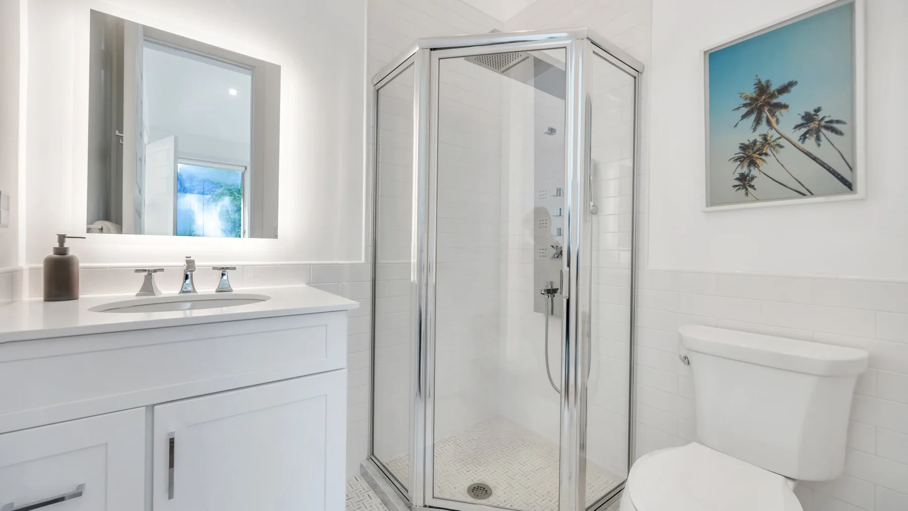 A bright bathroom with a sink, shower, and toilet.