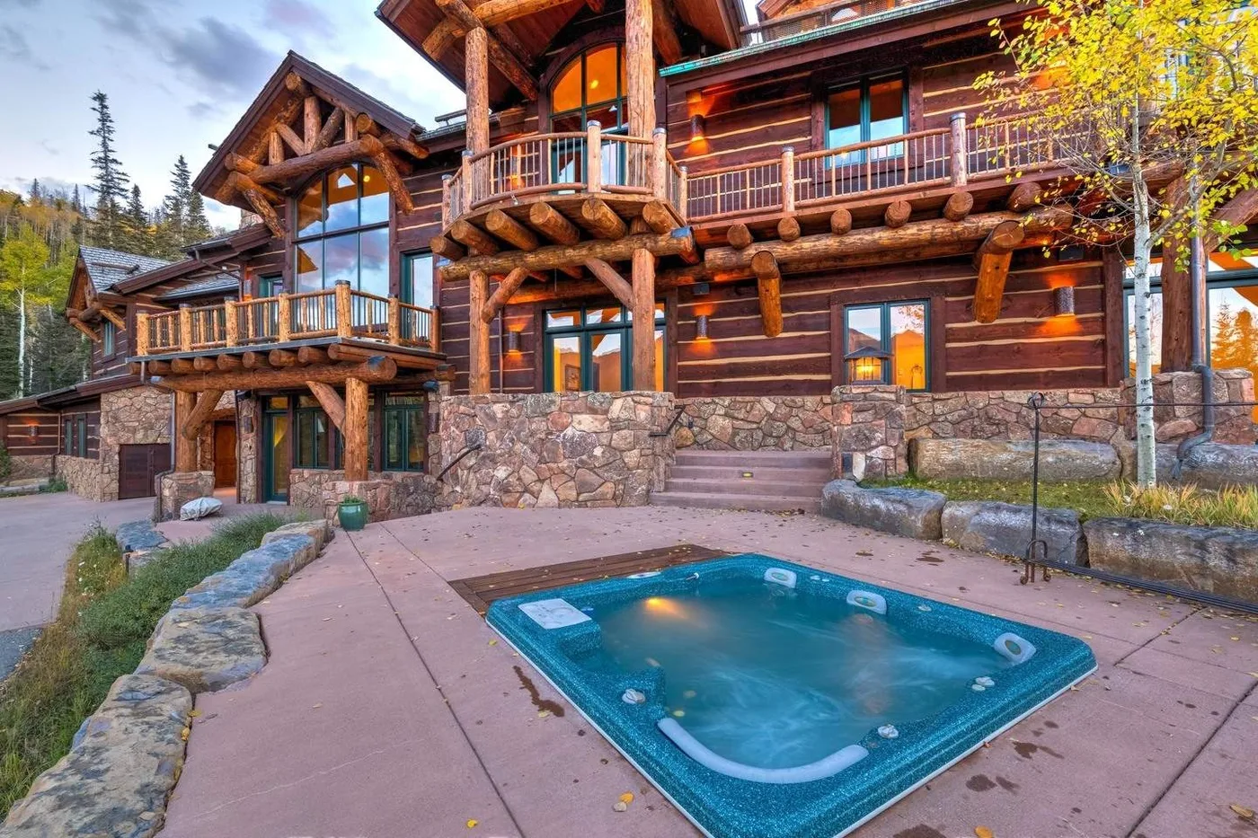 A log lodge with a small outdoor pool in the foreground.