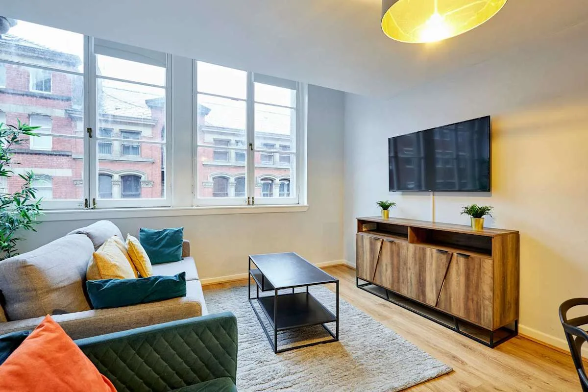 Living room with seating, a coffee table, and a television.