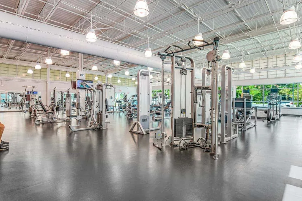 A spacious gym with exercise machines arranged across an open floor.