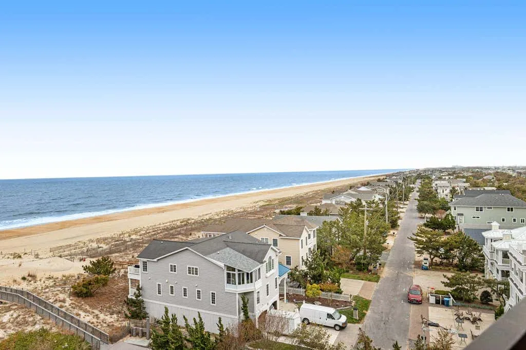 A coastal neighborhood beside a sandy beach and the ocean.