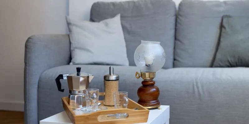 A living room seating area with a tray of drinks on a small table.