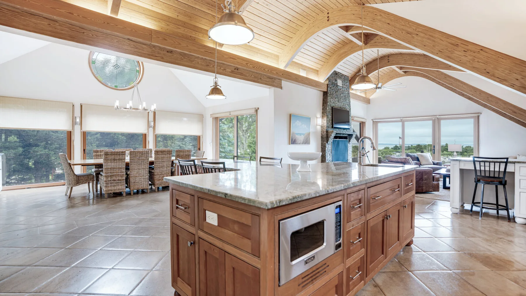 A spacious kitchen with a large central island and dining area.