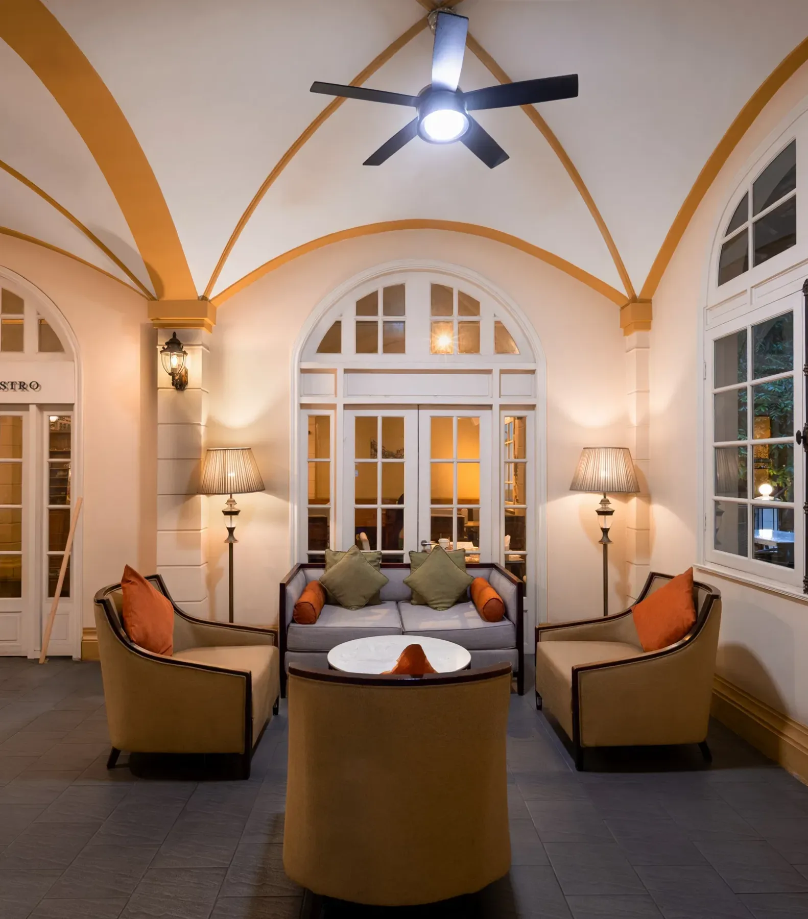 Lounge area with arched ceilings and large windows.