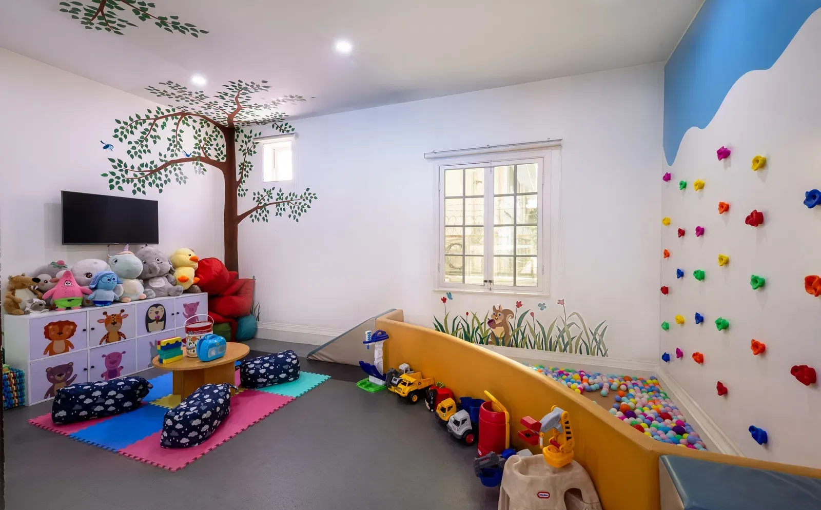 Children’s play area with toys and seating.