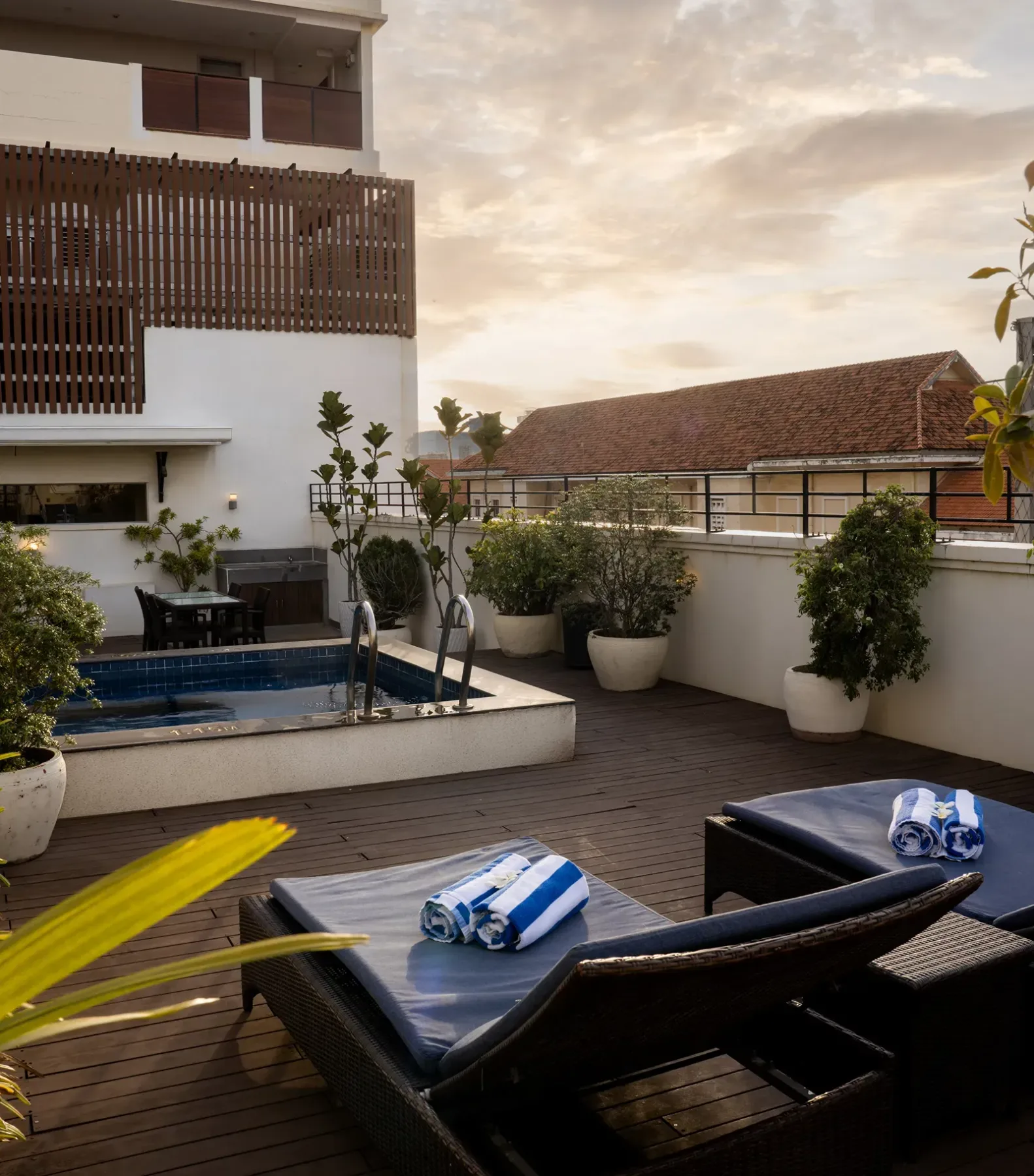 Outdoor terrace with lounge seating and sun loungers.