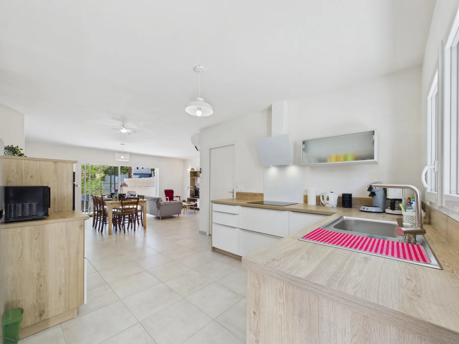 An open-plan kitchen and dining area with a light wood counter and dining table.