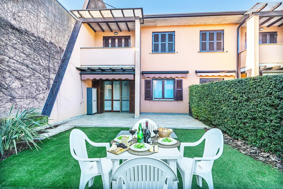 A courtyard dining area with outdoor seating and a table on the lawn.