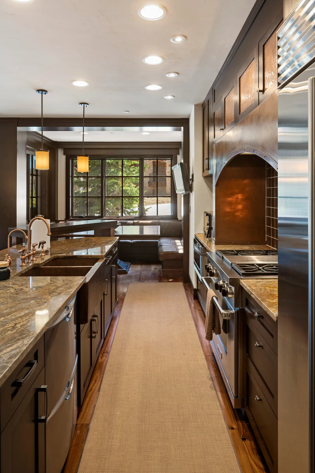 A kitchen with long counters and a central walkway.