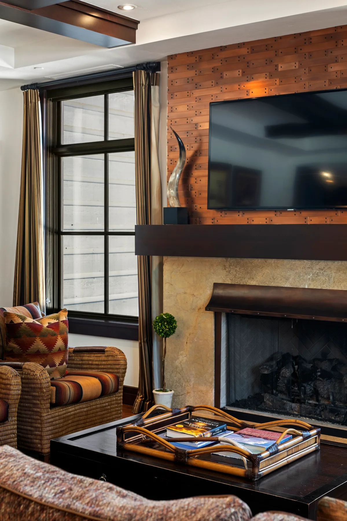 A living room with a fireplace, television, and seating around a coffee table.