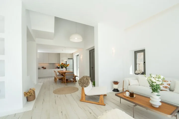 Bright living and dining area with a sofa and table.