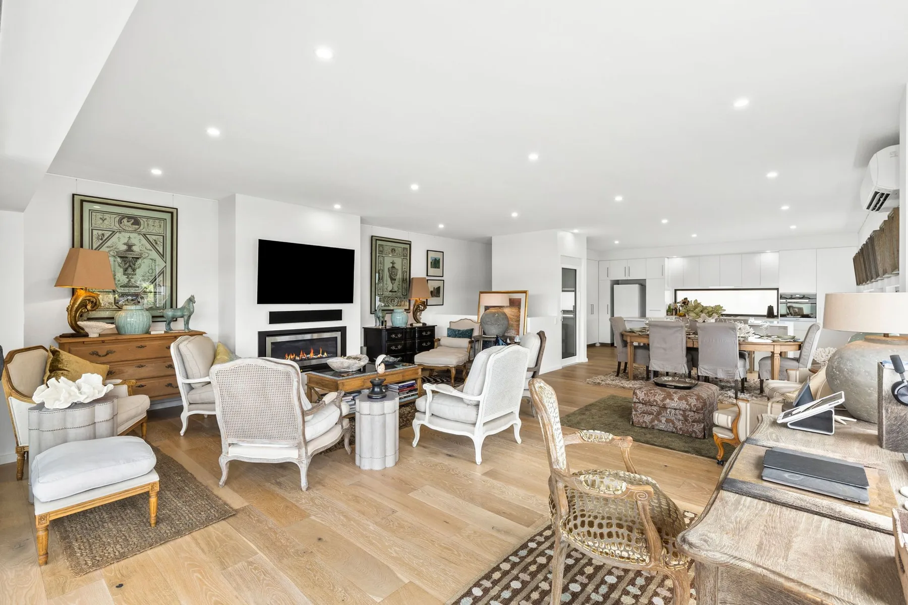 A bright open-plan living and dining room with seating and a dining table.