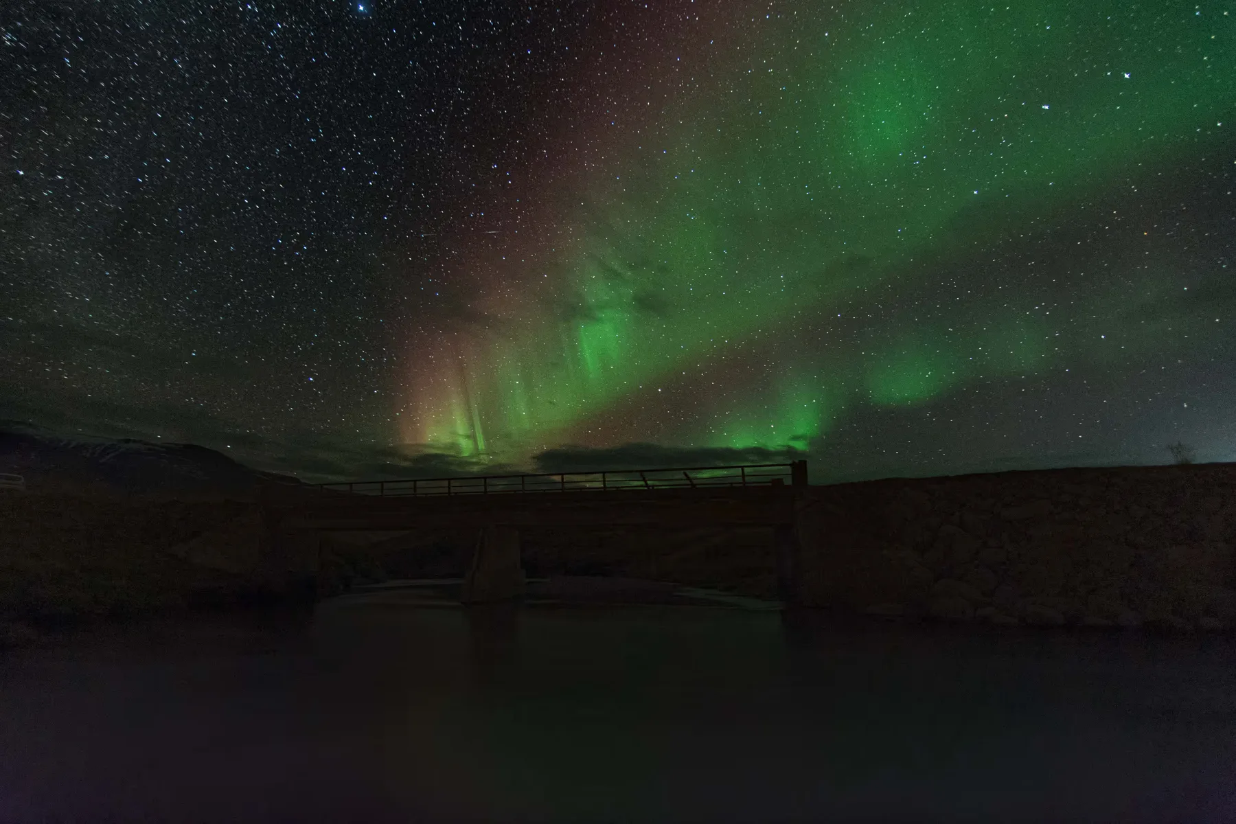 Northern lights above a bridge