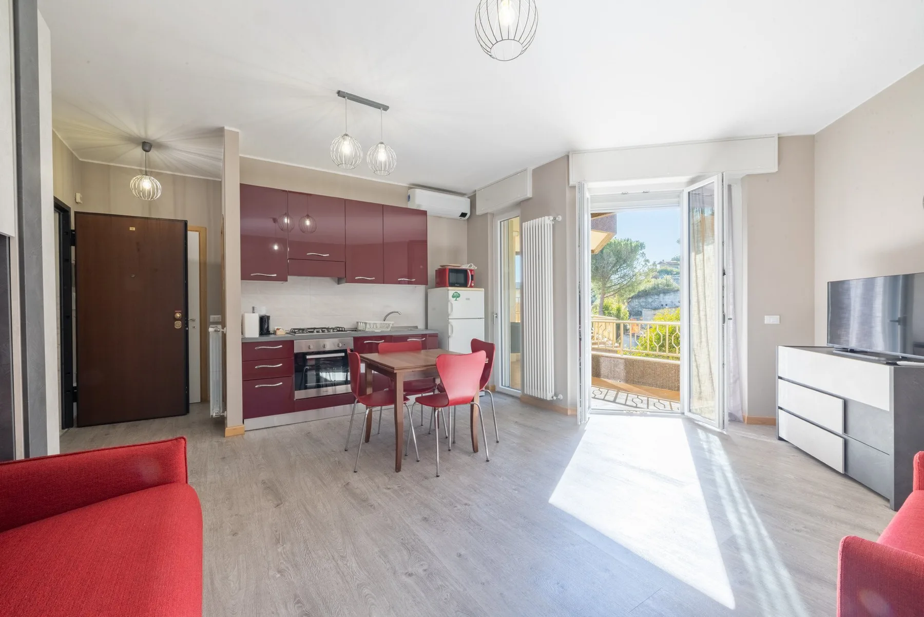 A bright open-plan kitchen and dining area opens onto a balcony.