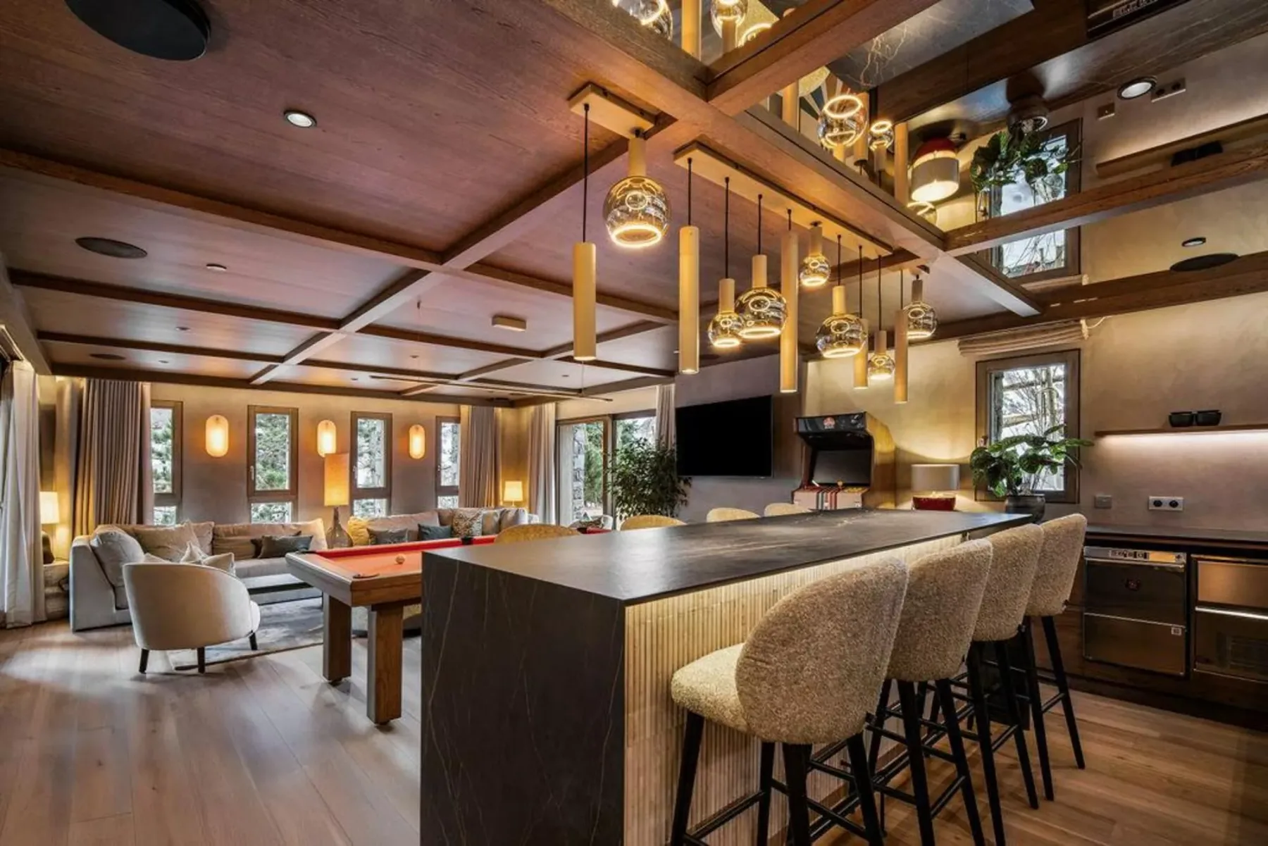 Una amplia zona de comedor y cocina cuenta con una larga barra con asientos.