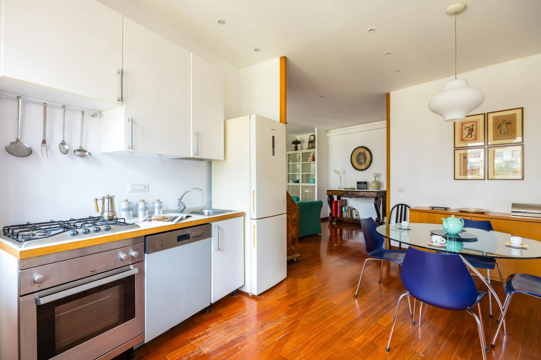 An open kitchen and dining area with a counter, table, and chairs.