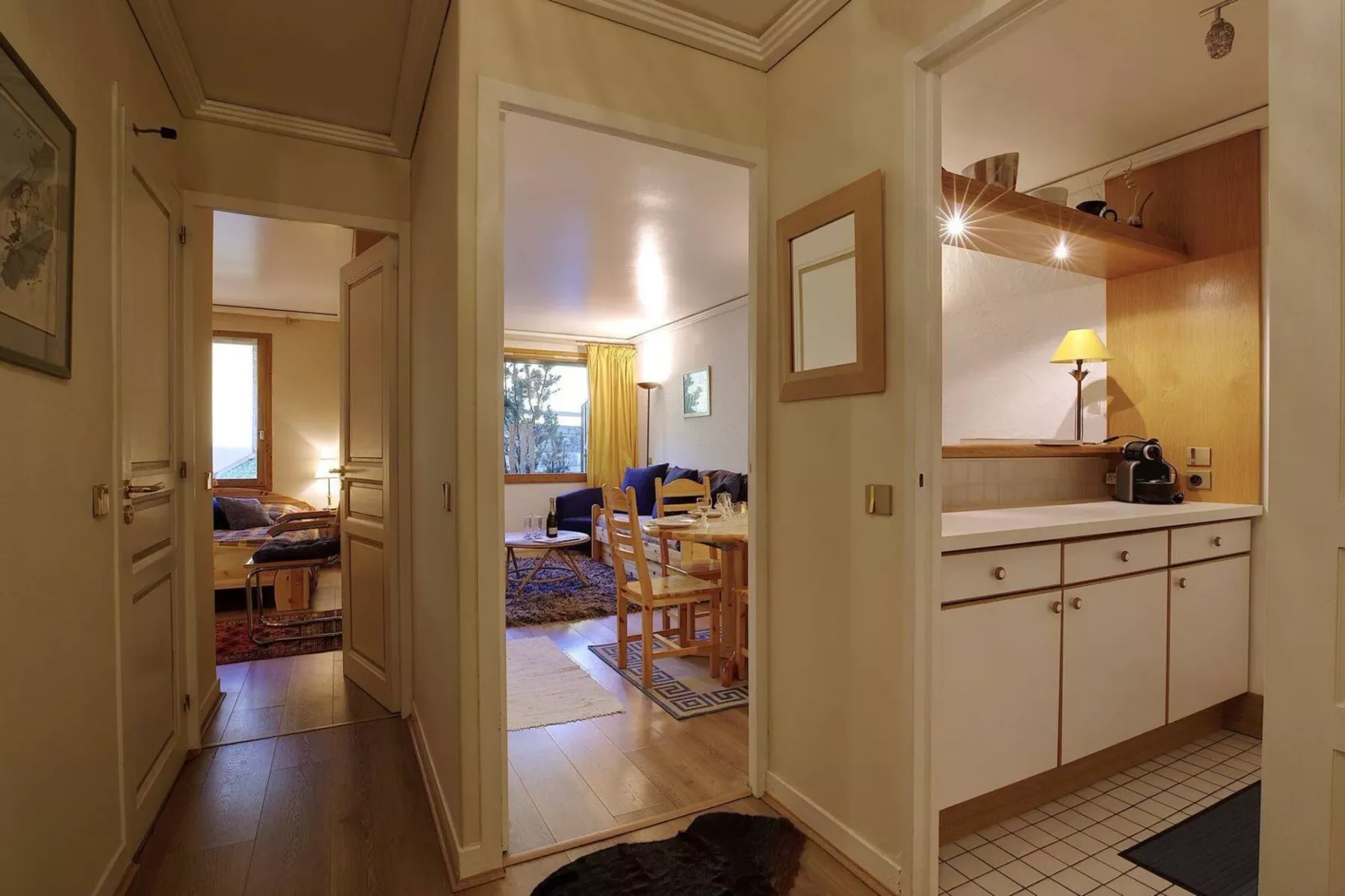 A hallway opens onto a dining area and a kitchenette.