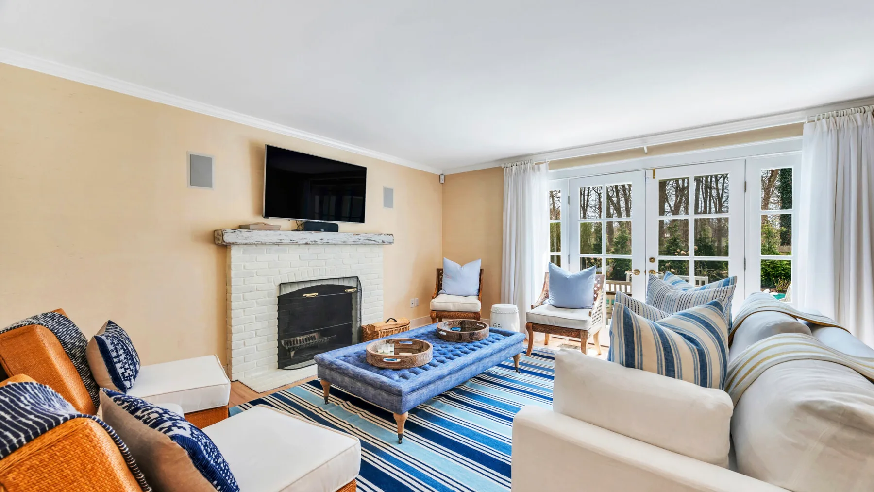 A living room with seating around a coffee table and a fireplace.