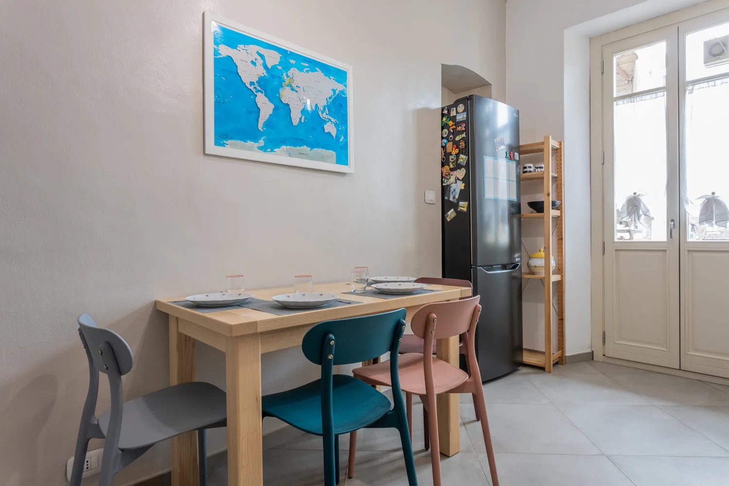 Un comedor con una mesa de madera y un mapa en la pared.