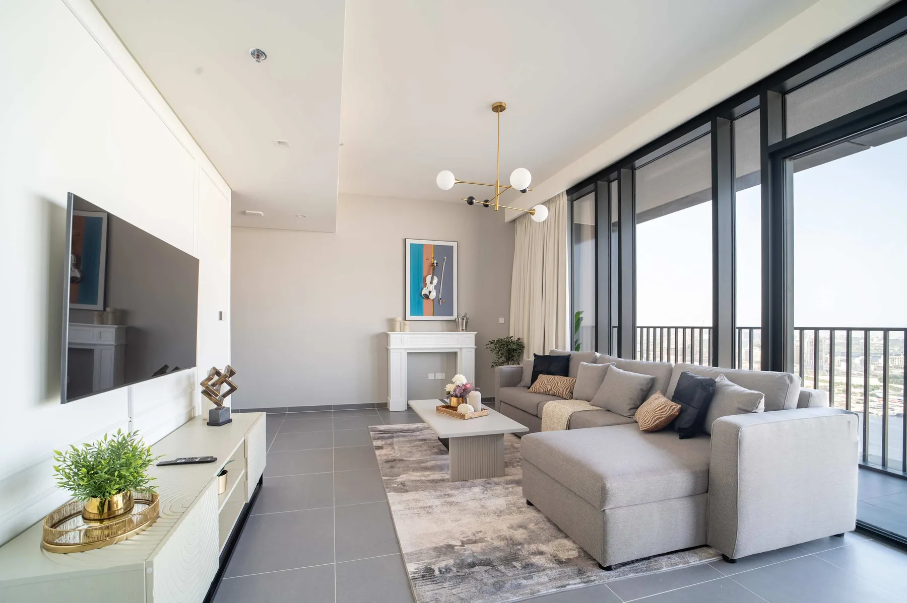 A bright living room with sectional seating beside large windows.