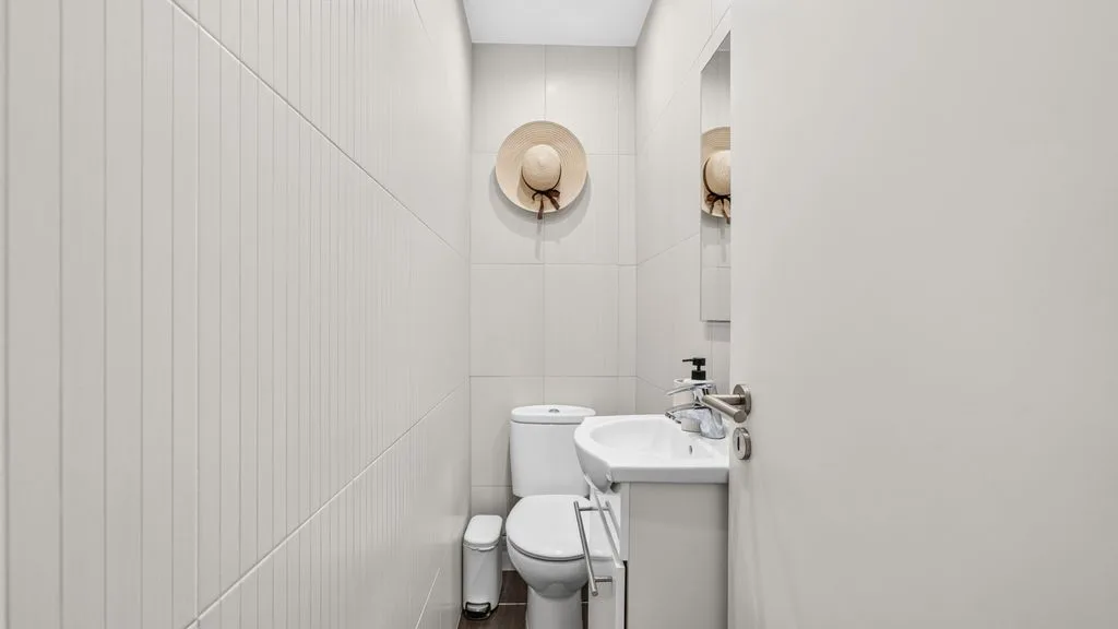 A bright bathroom with a toilet and sink.