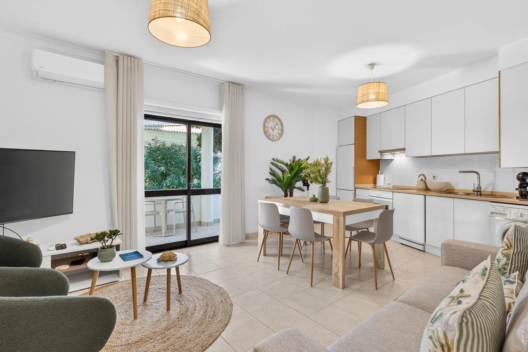 An open-plan living and dining area with a dining table beside the kitchen.