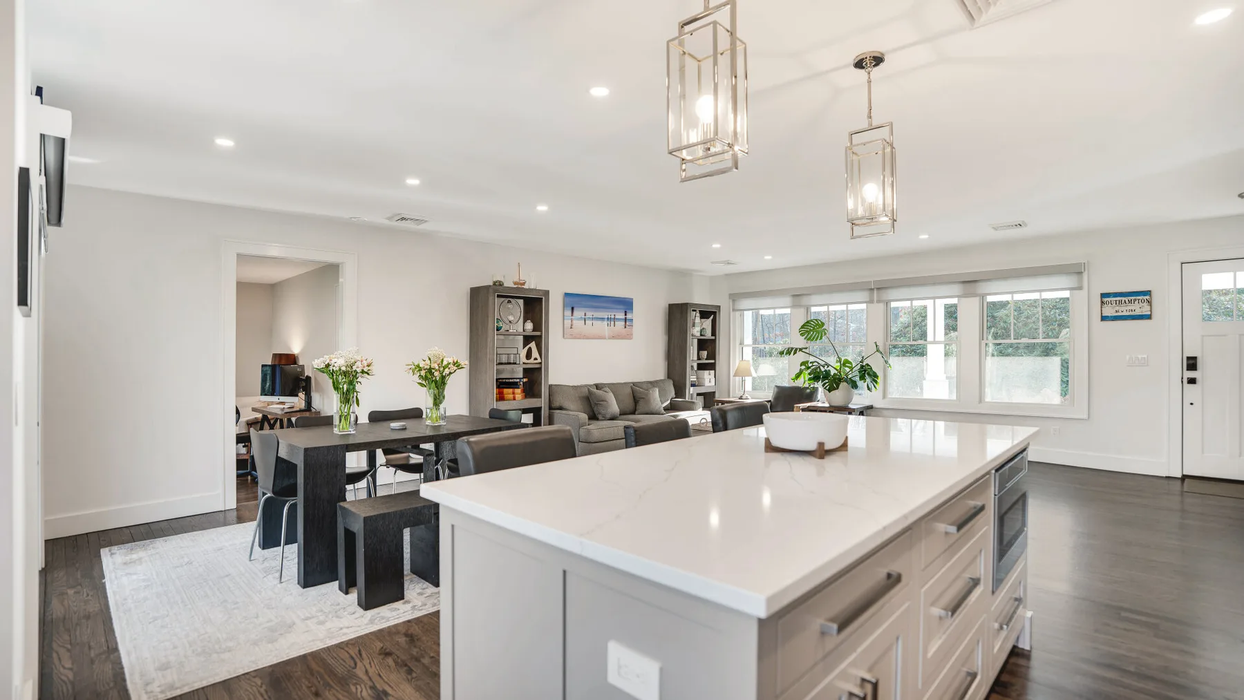 A bright open-plan kitchen and living area with a large central island.