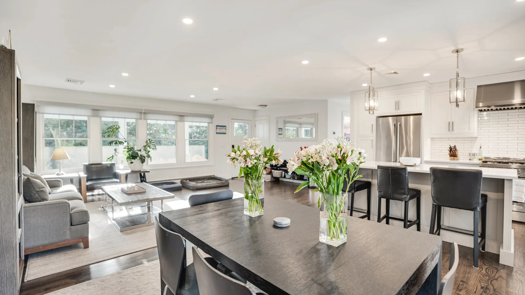 An open-plan living and dining area with a large table and kitchen island.