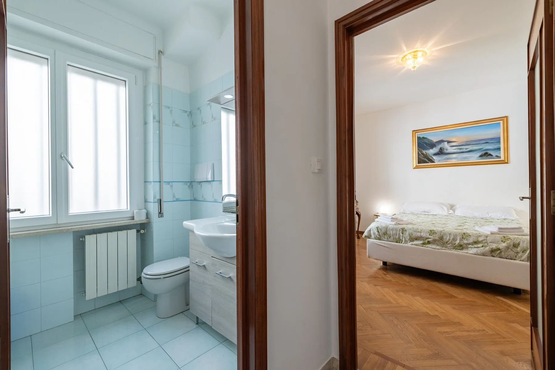 A bathroom and bedroom are visible through adjacent doorways.