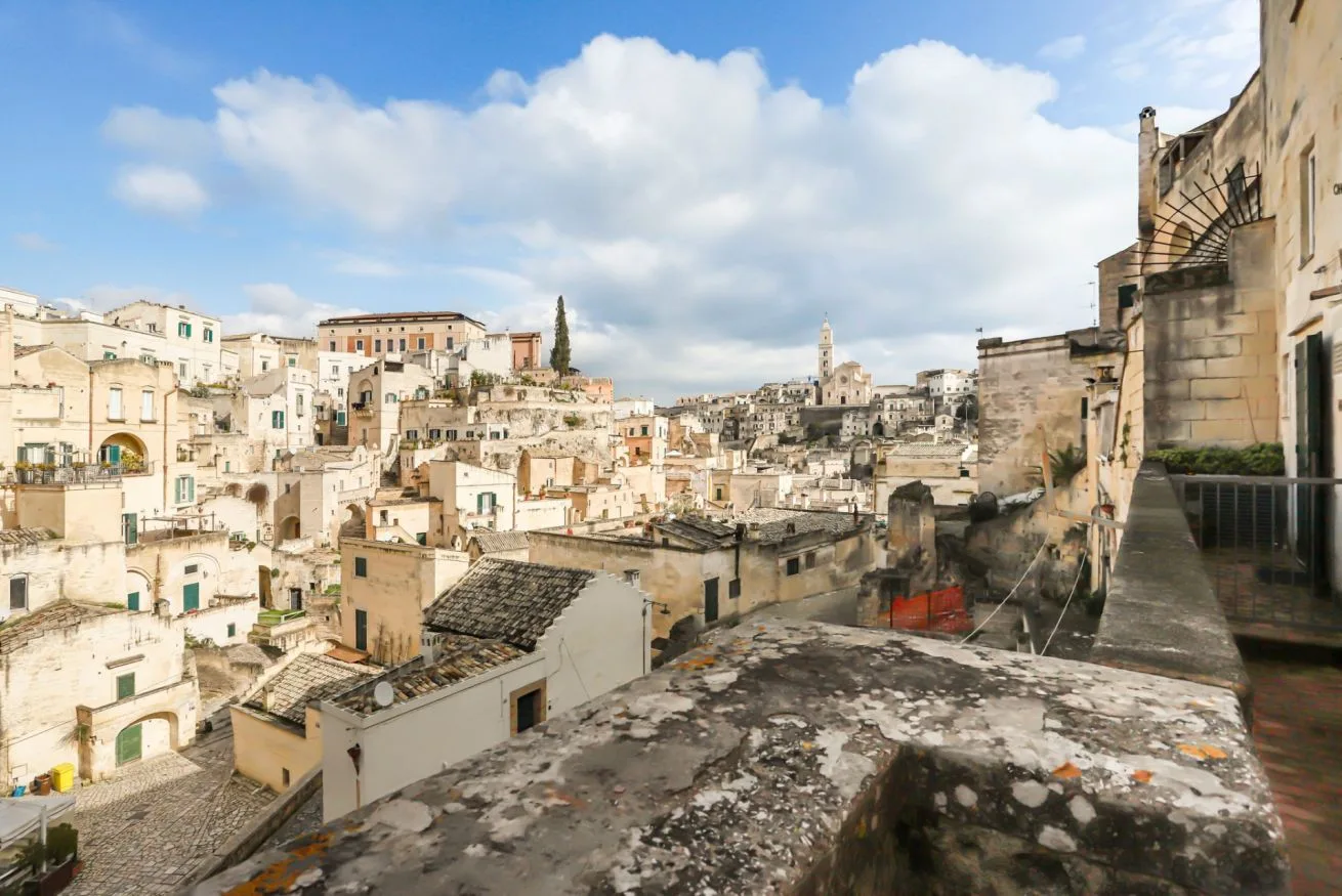 A panoramic view of a historic hillside town with stone buildings and rooftops.