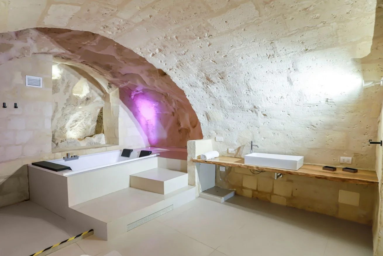 A bathroom with a built-in bathtub and a long vanity counter.