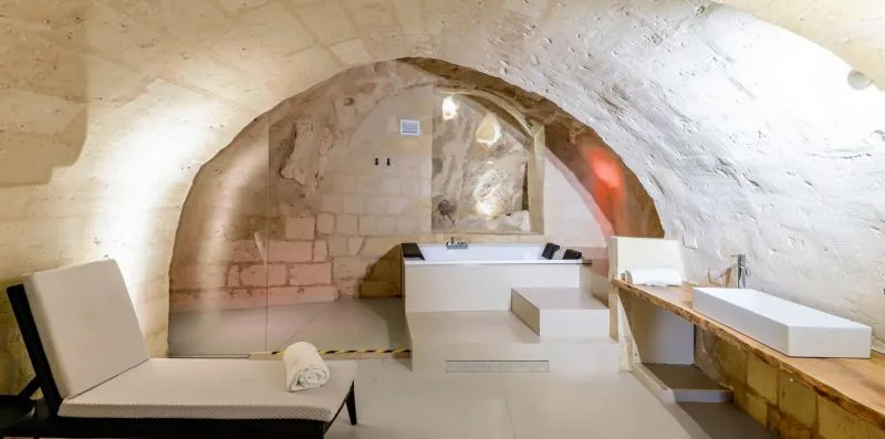 A curved stone interior with built-in seating and a raised central platform.