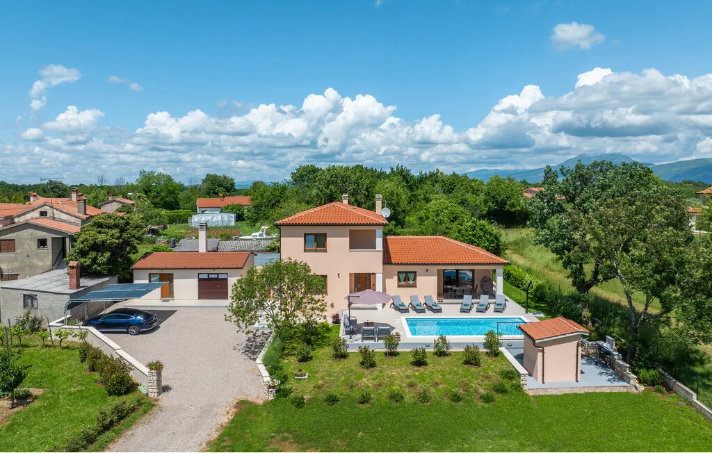 Una casa de campo con piscina y zonas verdes.