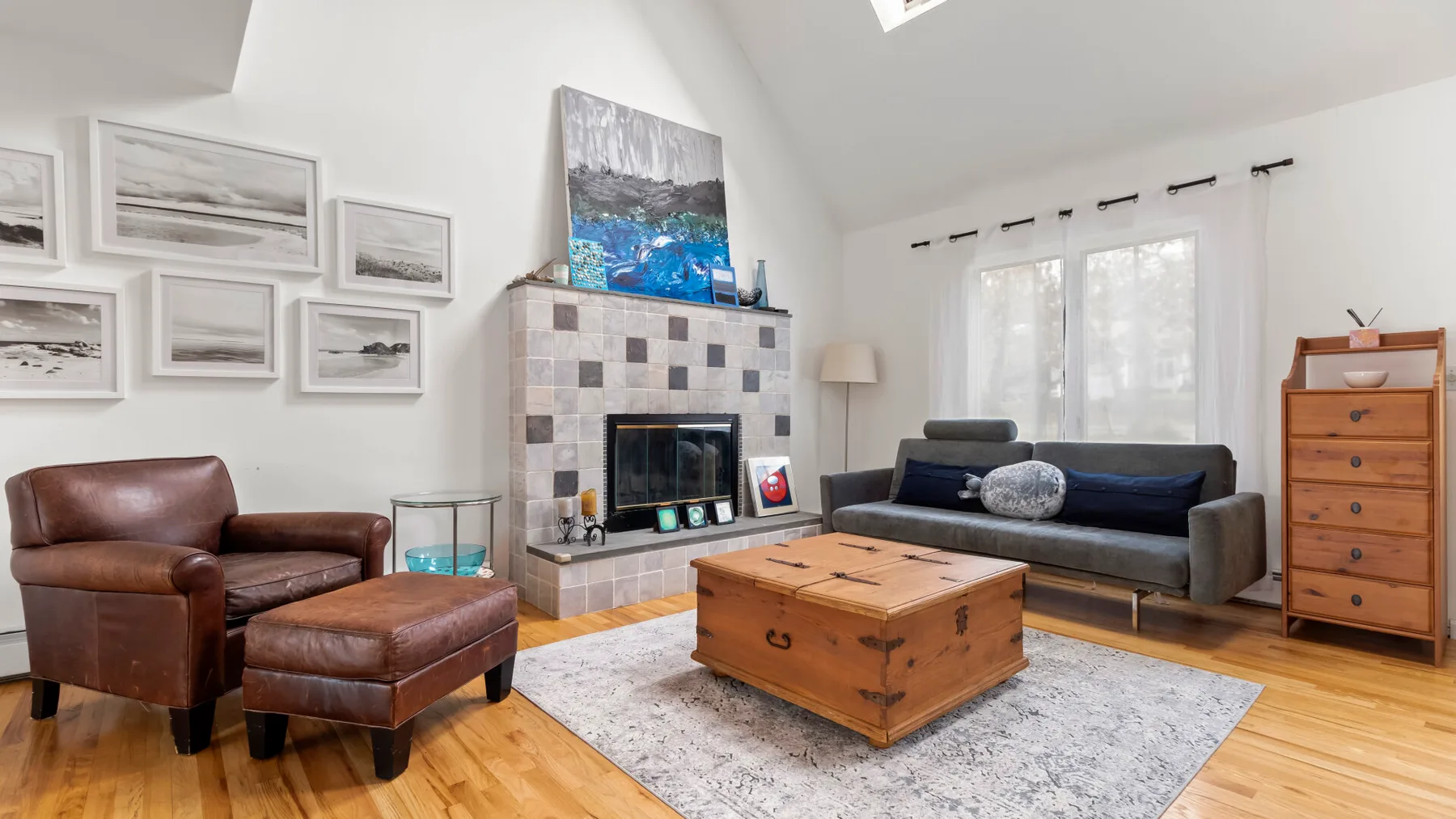 A bright living room with seating arranged around a central wooden coffee table.
