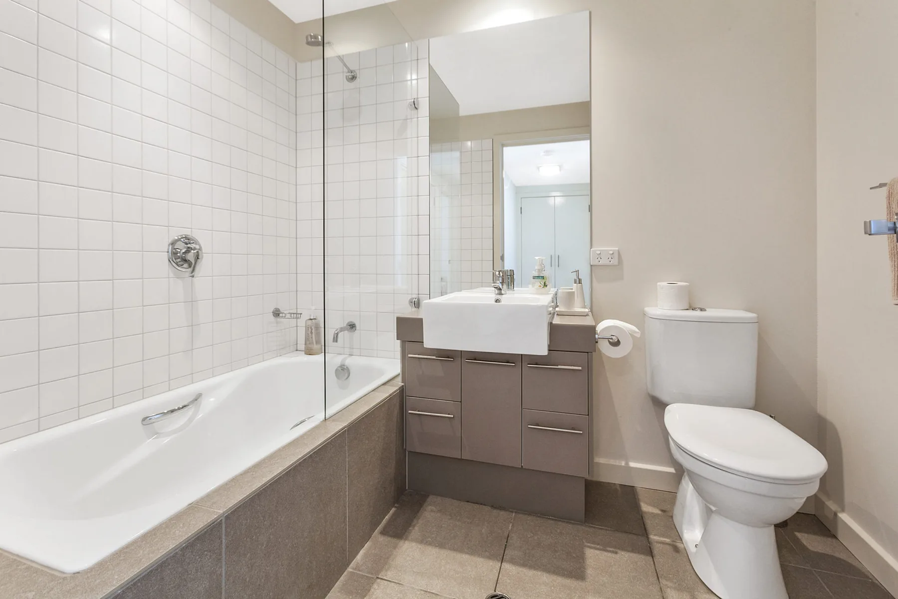 A bathroom with a bathtub, sink, and toilet.