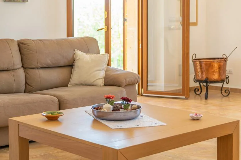 A living room with a seating area and a wooden coffee table.