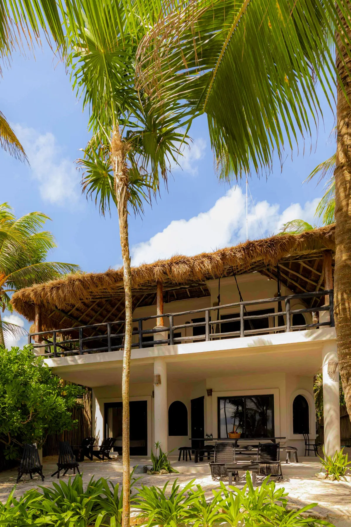 Tropical house with balcony and outdoor seating