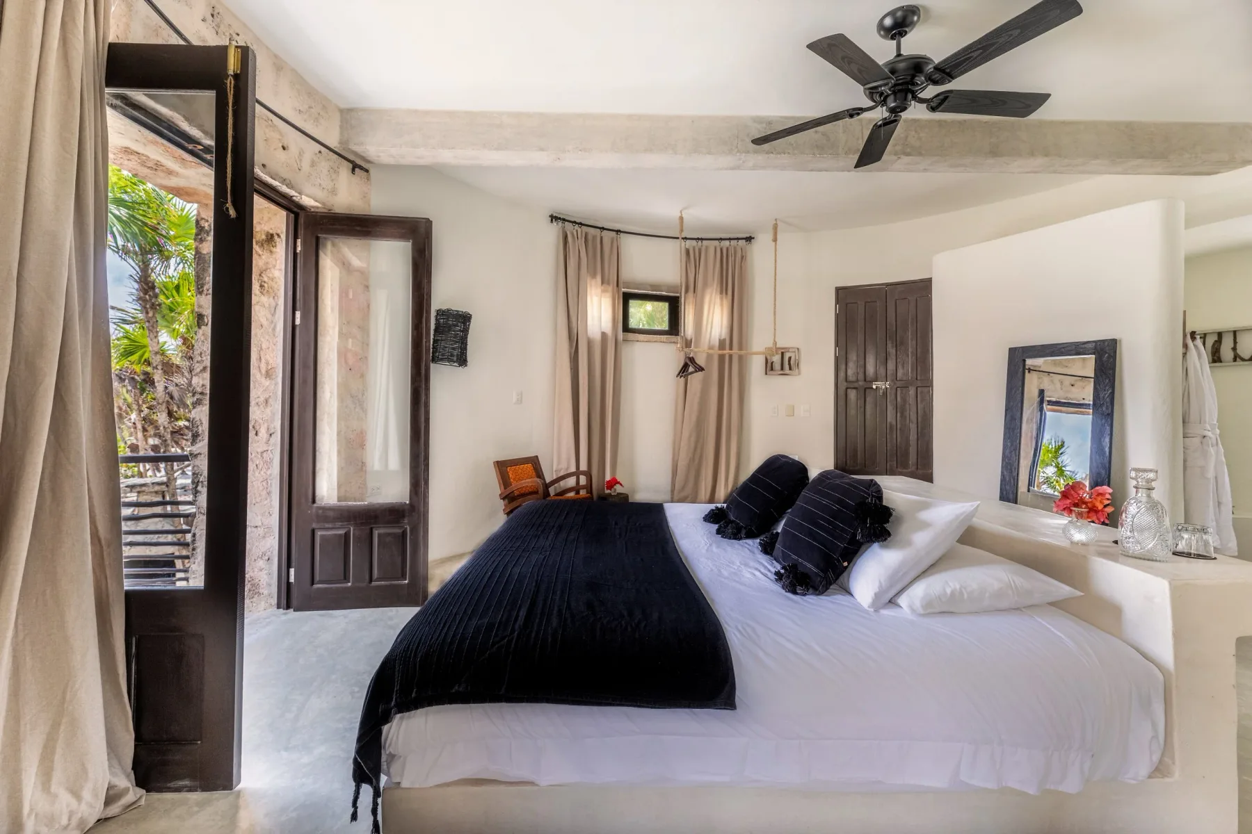 Guest bedroom with a large bed and ceiling fan