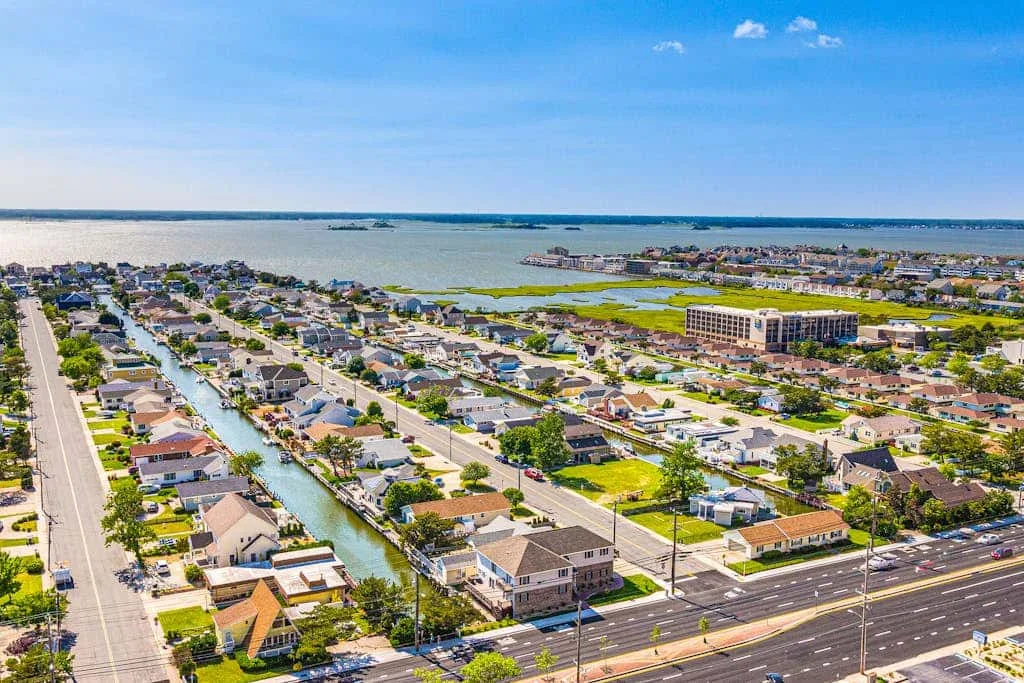 An aerial view of a coastal neighborhood with canals and homes.