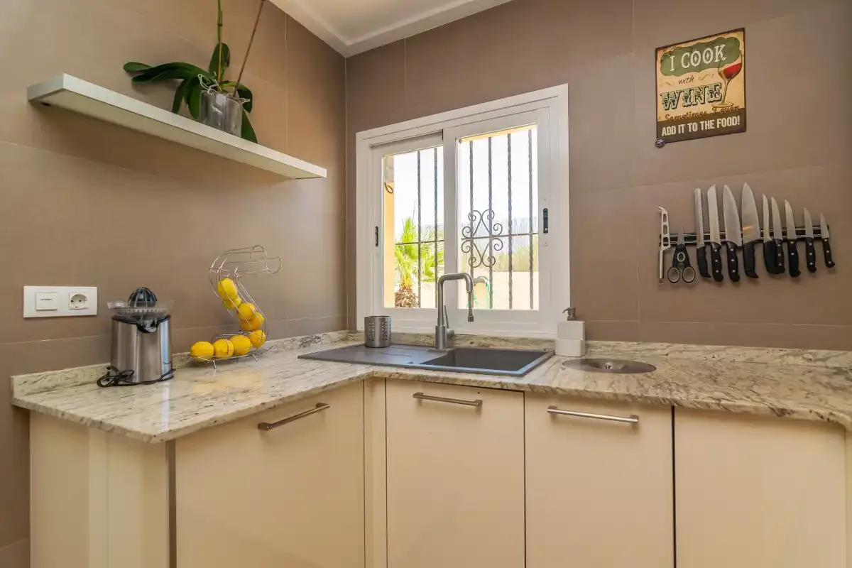 Una cocina con encimera, fregadero y ventana.