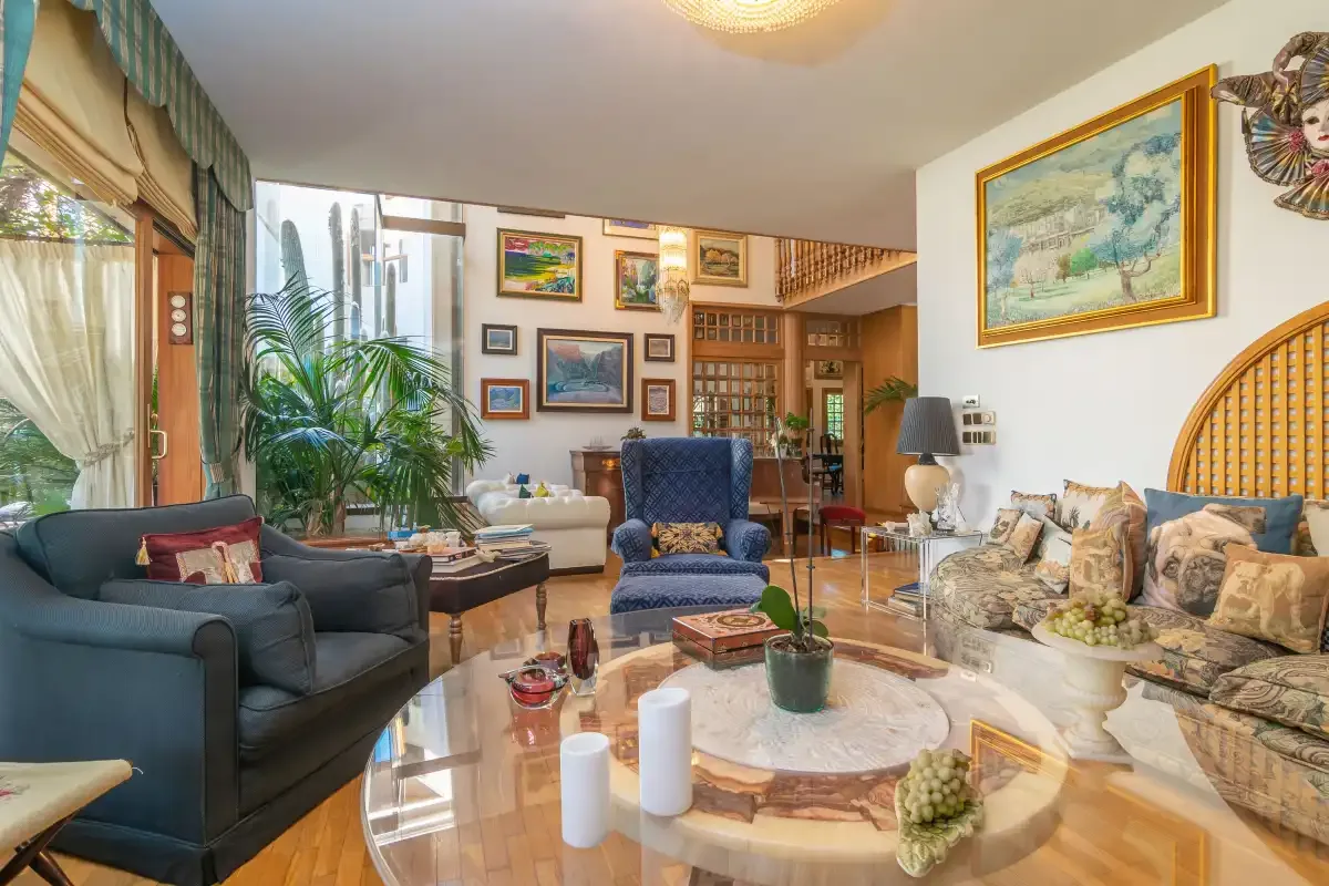 A living room with seating, a coffee table, and framed artwork.