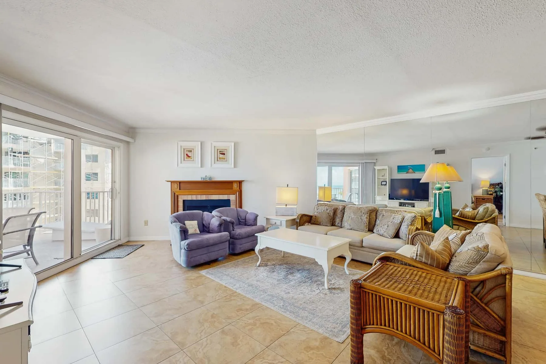 A bright living room with seating arranged around a white coffee table.