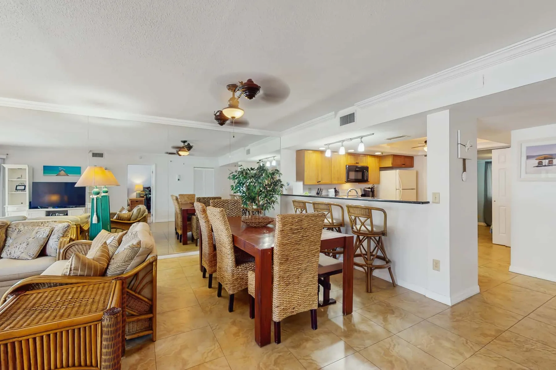 An open-plan living and dining area with a kitchen and a long dining table.