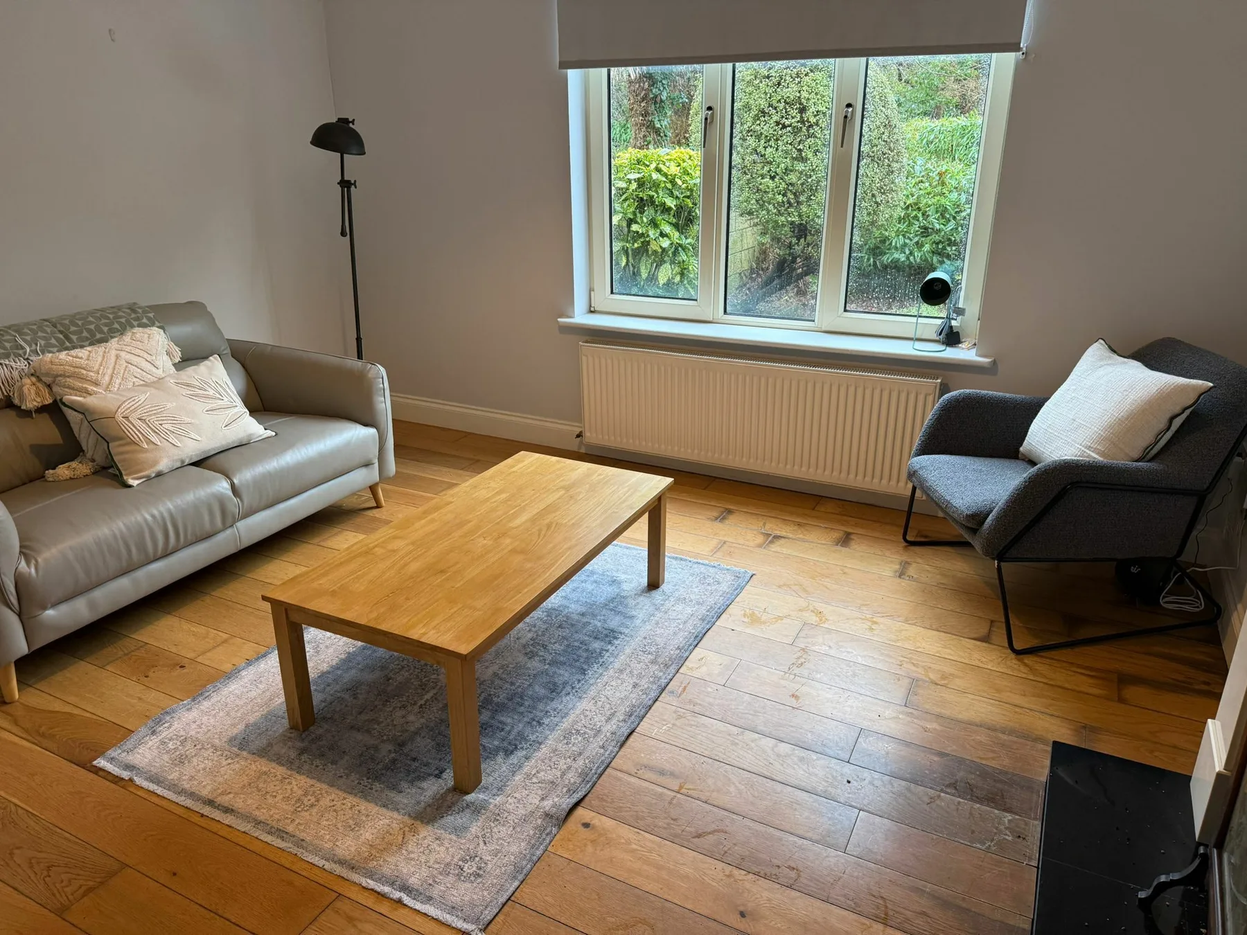 A living room with seating around a wooden coffee table.