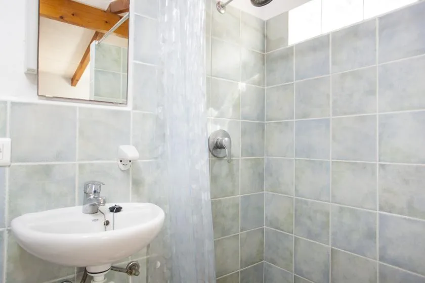 Un baño alicatado con lavabo y ducha.
